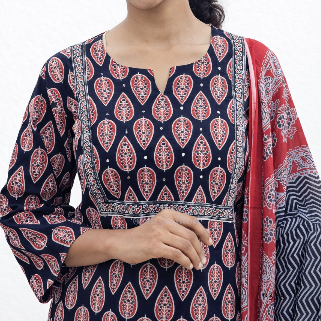 Woman wearing a navy blue patterned kurta with a red and white dupatta on a white background