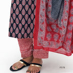 Traditional patterned pants with a red and white scarf on a white background