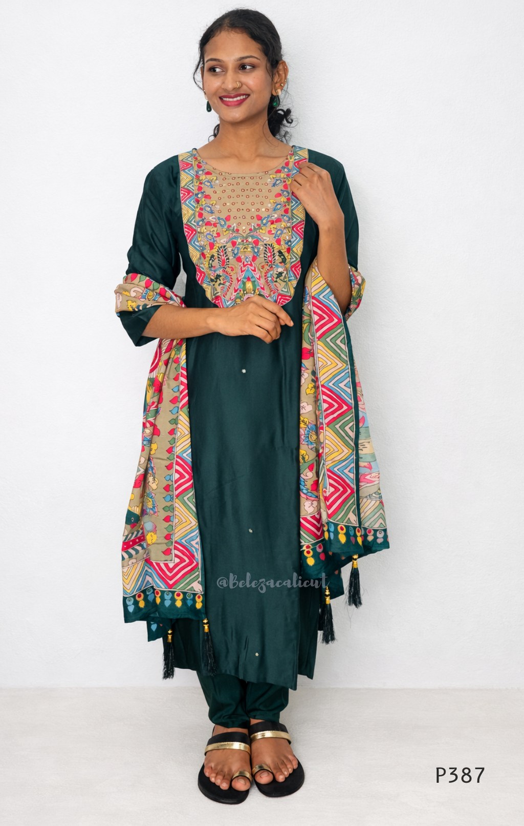 Woman wearing a traditional outfit with a colorful dupatta on a white background