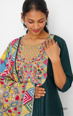 Woman wearing a colorful patterned top with a plain background
