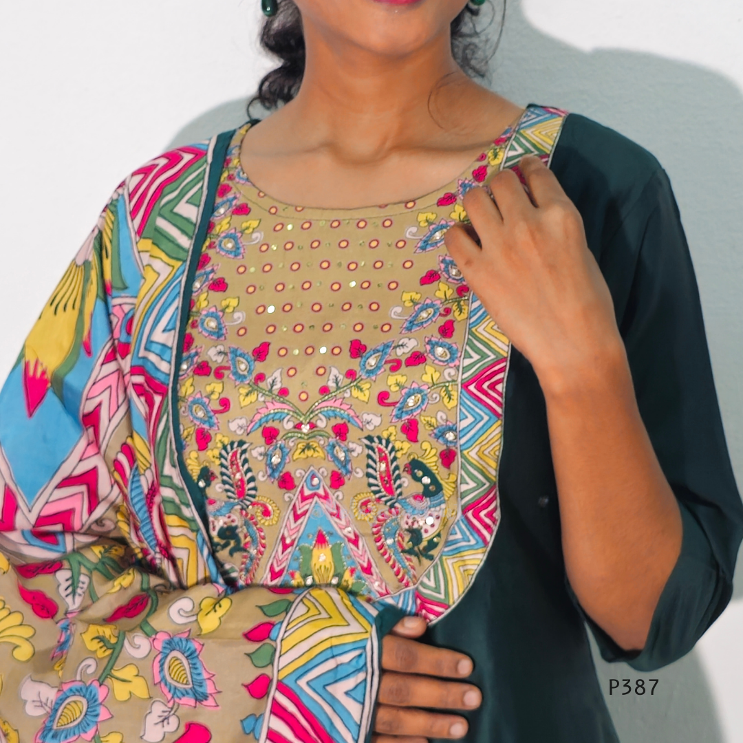 Woman wearing a colorful patterned top with a plain background