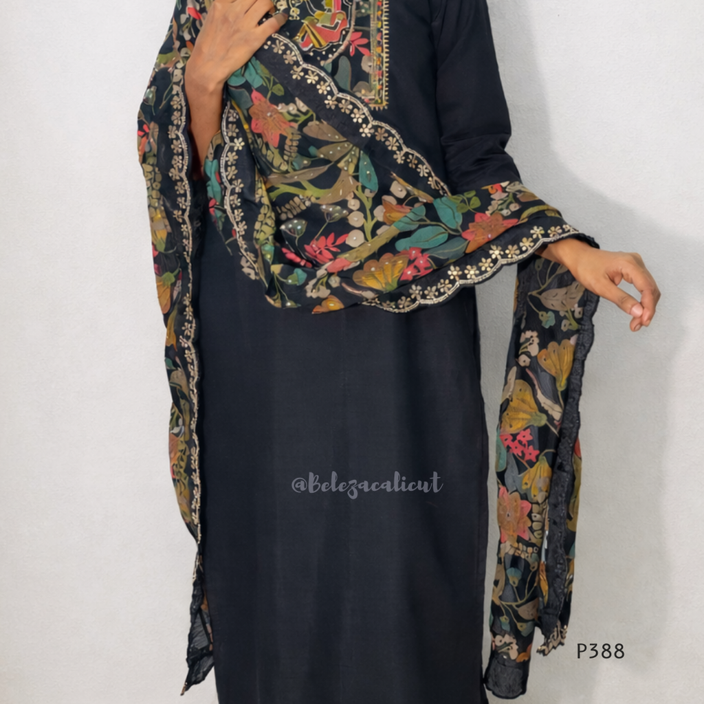 Black dress with a colorful floral scarf draped over the shoulder on a white background
