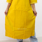 Yellow kurta worn by a person on a white background