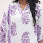 White garment with purple floral patterns worn by a person