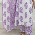 Purple and white floral patterned outfit on a neutral background