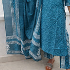 Blue patterned fabric draped over a person on a light background