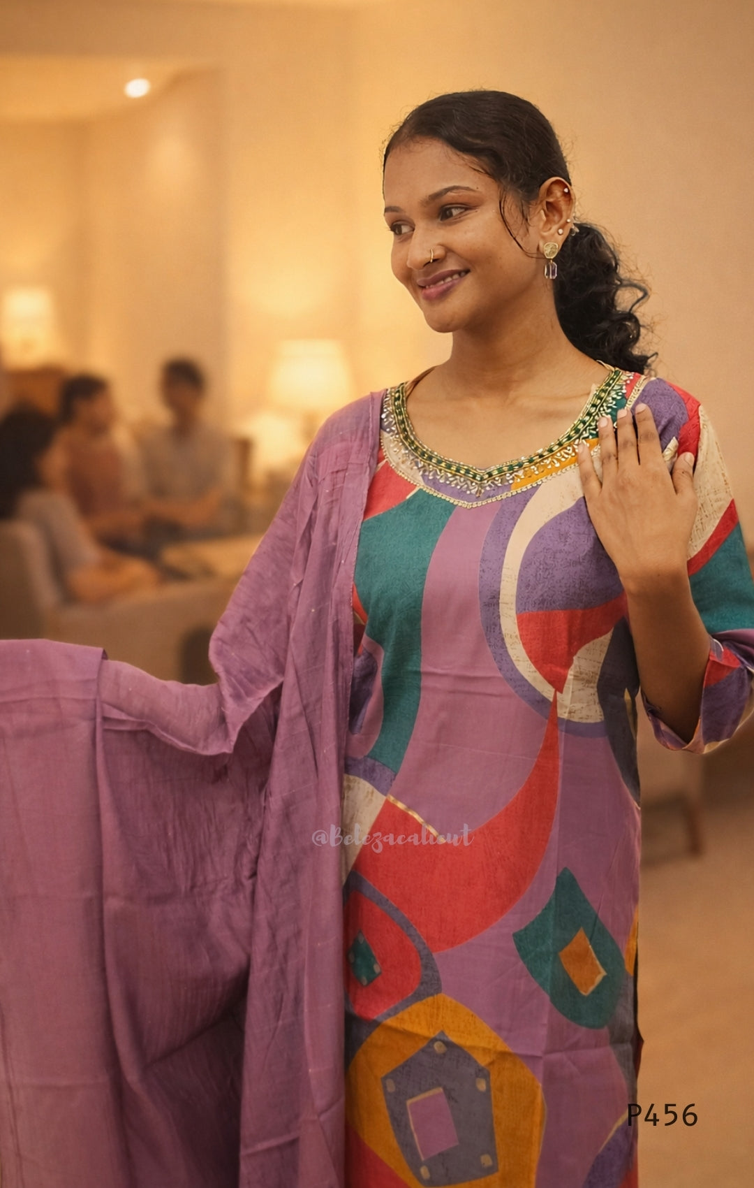 Woman in a colorful traditional outfit with a blurred background