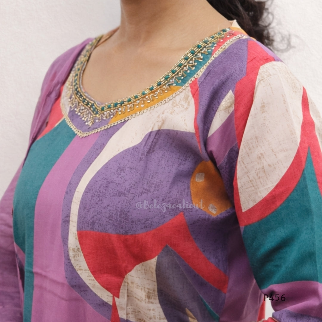 Colorful traditional outfit with intricate embroidery on a plain background