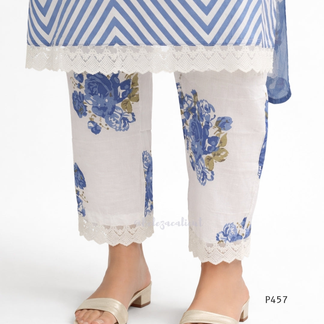 White pants with blue floral patterns and lace trim worn by a model on a white background.