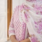 Person wearing a floral scarf with pink and white patterns