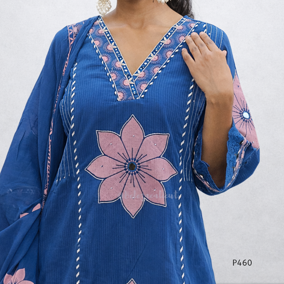 Blue dress with pink floral design and intricate patterns on a plain background