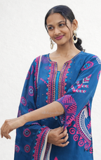Woman wearing a blue patterned dress with a white background
