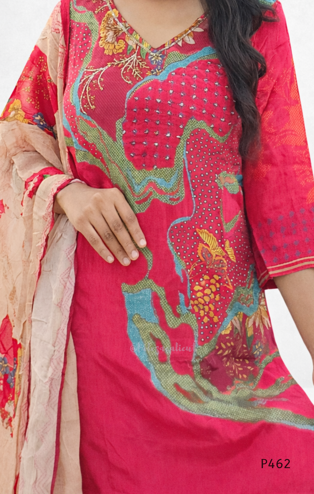 Woman wearing a red embroidered dress with a matching dupatta on a white background