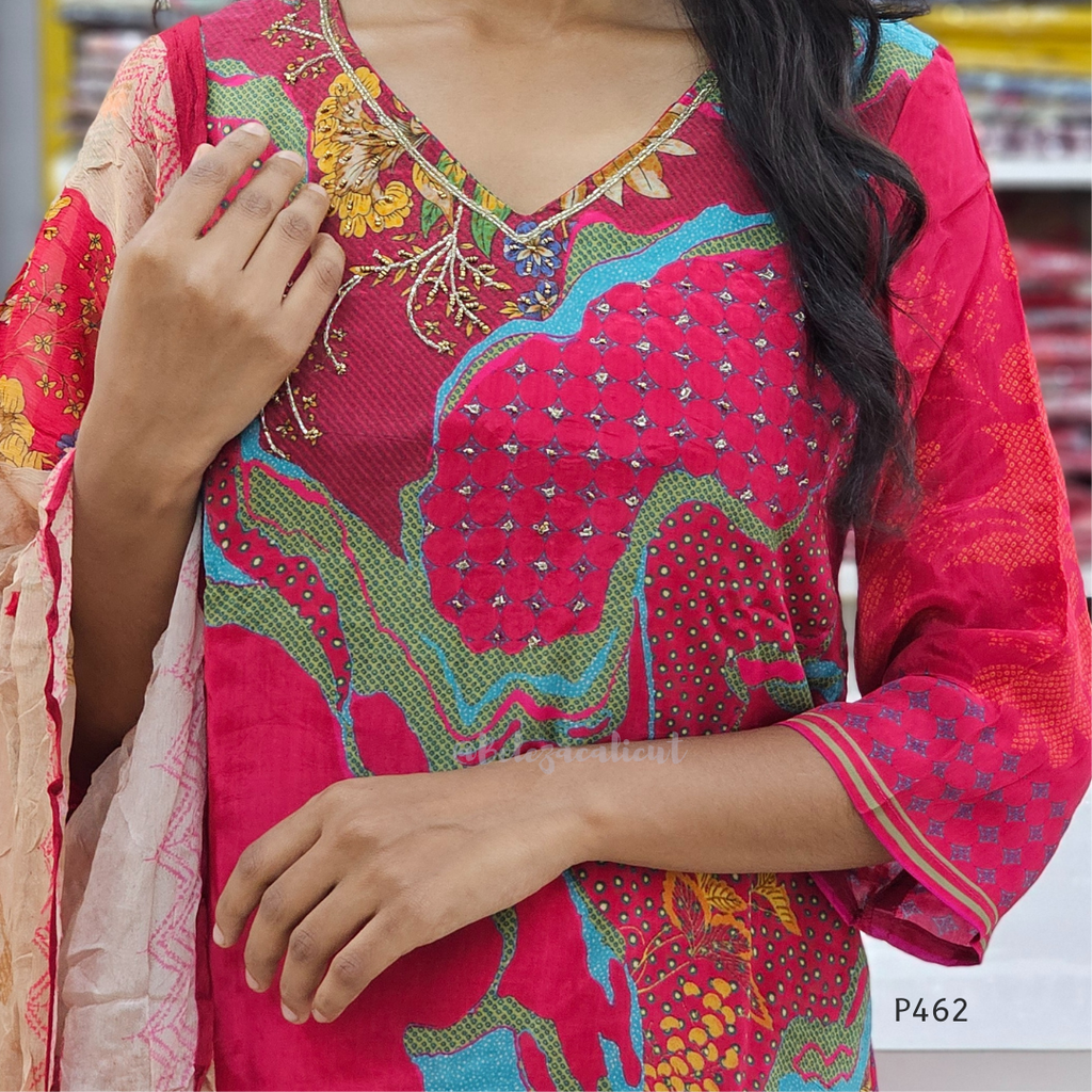 Person wearing a vibrant pink traditional outfit with intricate patterns