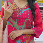 Person wearing a vibrant pink traditional outfit with intricate patterns