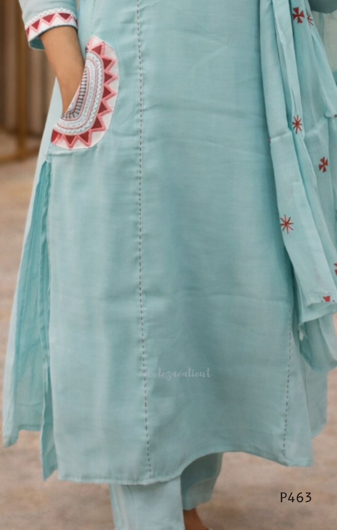 Light blue embroidered outfit with a matching dupatta on a blurred background