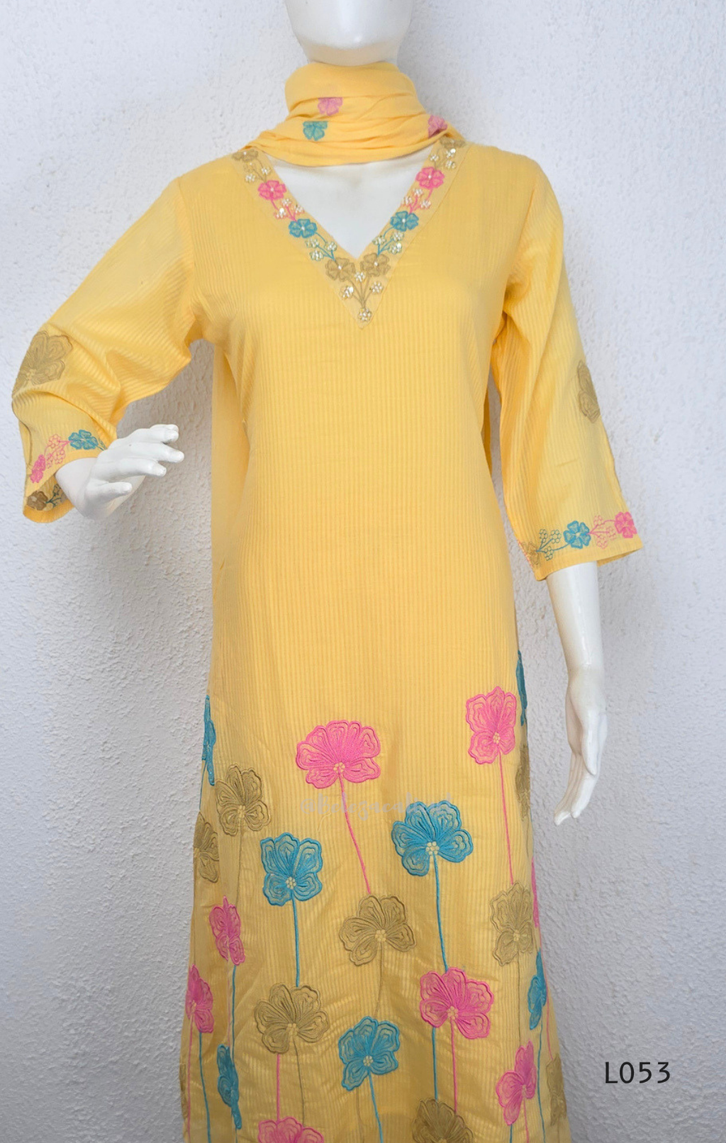 Cream mul cotton churidar set with lining, pastel pink and powder blue floral embroidery, matching dupatta, 3/4 sleeves and V-neck bead detail 