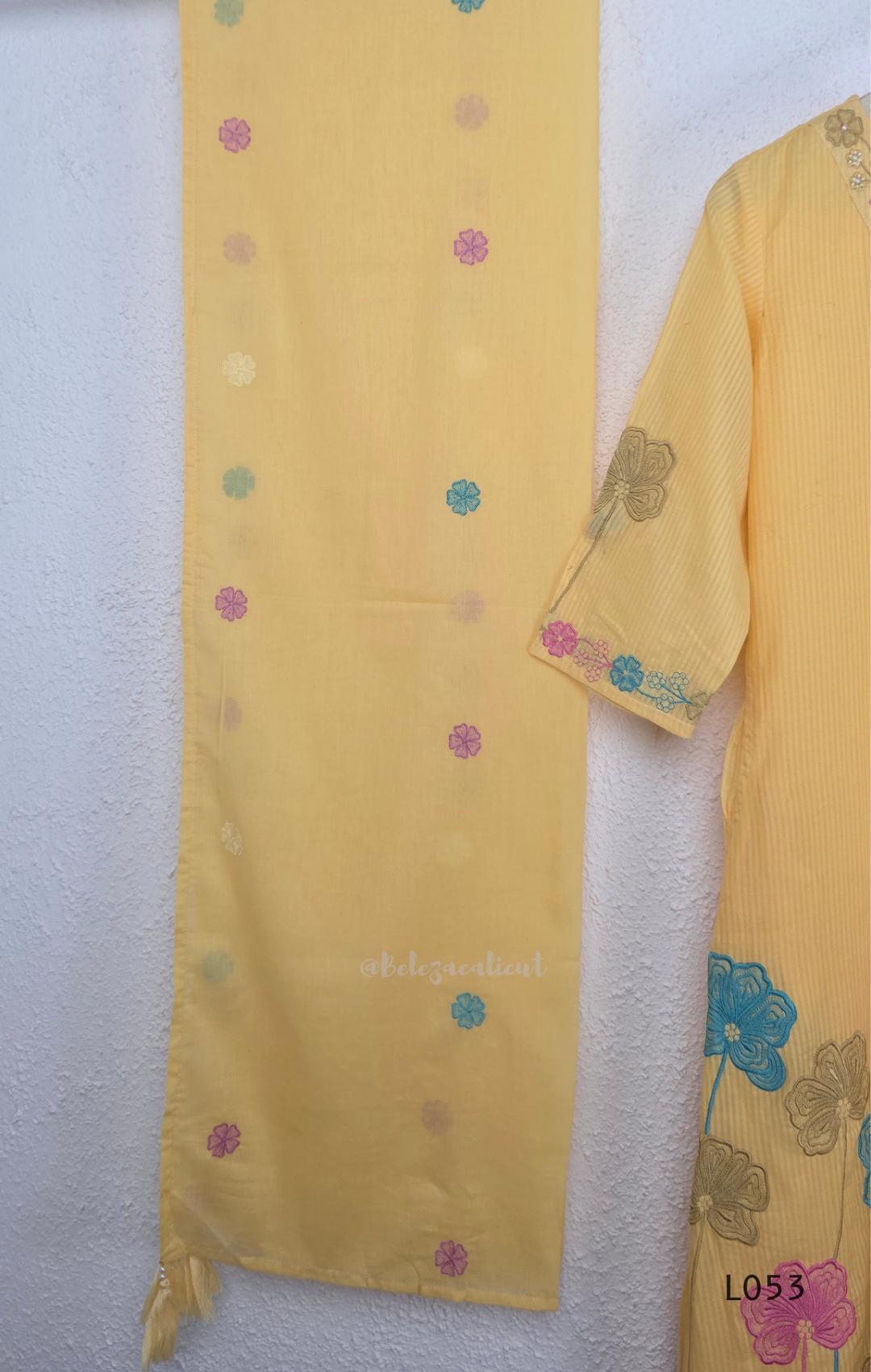 Cream mul cotton churidar set with lining, pastel pink and powder blue floral embroidery, matching dupatta, 3/4 sleeves and V-neck bead detail 