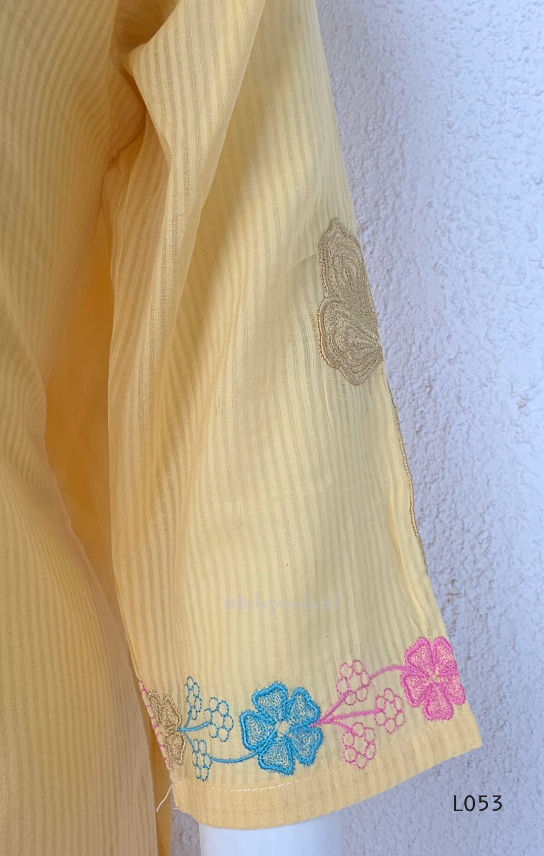 Cream mul cotton churidar set with lining, pastel pink and powder blue floral embroidery, matching dupatta, 3/4 sleeves and V-neck bead detail 