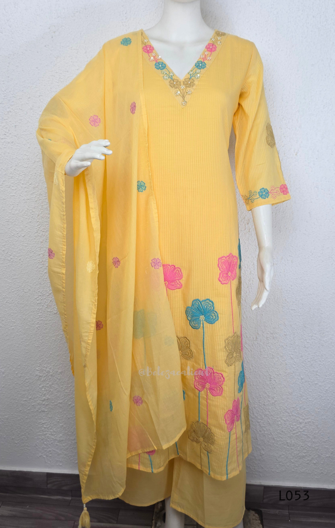 Cream mul cotton churidar set with lining, pastel pink and powder blue floral embroidery, matching dupatta, 3/4 sleeves and V-neck bead detail 