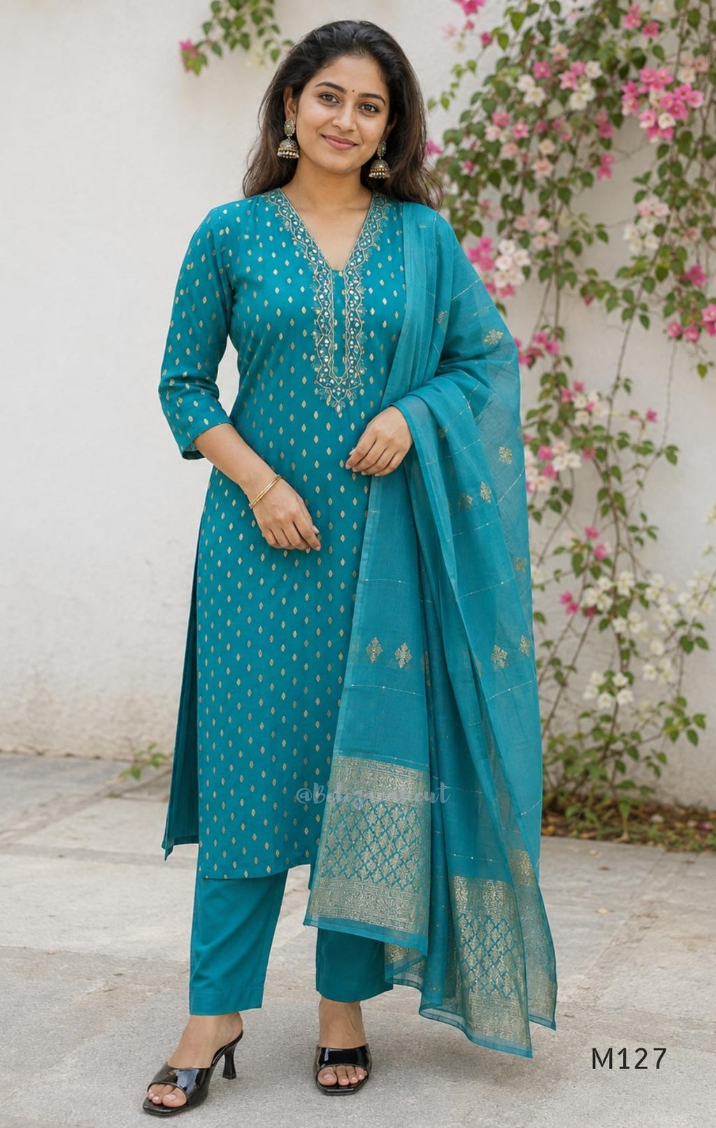 Peacock teal silk blend 3-piece churidar set with gold buti motifs, decorated V-neckline, plain matching bottom and gold-bordered dupatta.