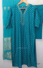 Peacock teal silk blend 3-piece churidar set with gold buti motifs, decorated V-neckline, plain matching bottom and gold-bordered dupatta.