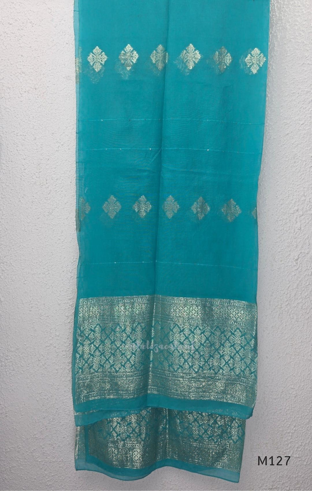 Peacock teal silk blend 3-piece churidar set with gold buti motifs, decorated V-neckline, plain matching bottom and gold-bordered dupatta.
