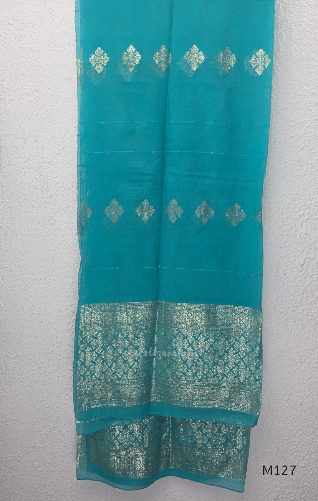 Peacock teal silk blend 3-piece churidar set with gold buti motifs, decorated V-neckline, plain matching bottom and gold-bordered dupatta.