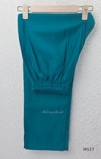 Peacock teal silk blend 3-piece churidar set with gold buti motifs, decorated V-neckline, plain matching bottom and gold-bordered dupatta.