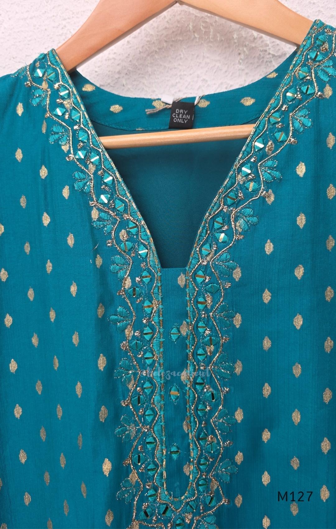 Peacock teal silk blend 3-piece churidar set with gold buti motifs, decorated V-neckline, plain matching bottom and gold-bordered dupatta.