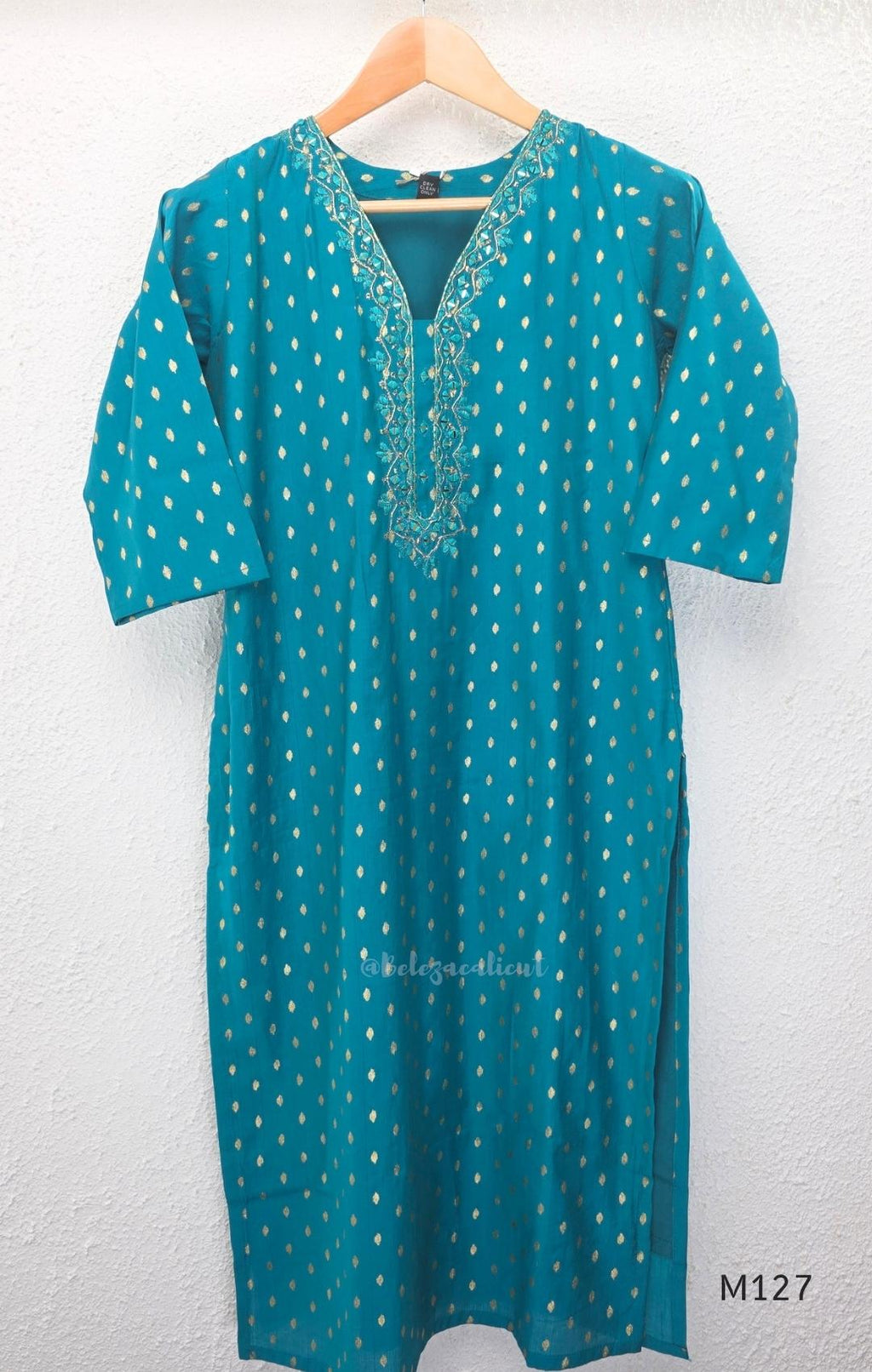 Peacock teal silk blend 3-piece churidar set with gold buti motifs, decorated V-neckline, plain matching bottom and gold-bordered dupatta.