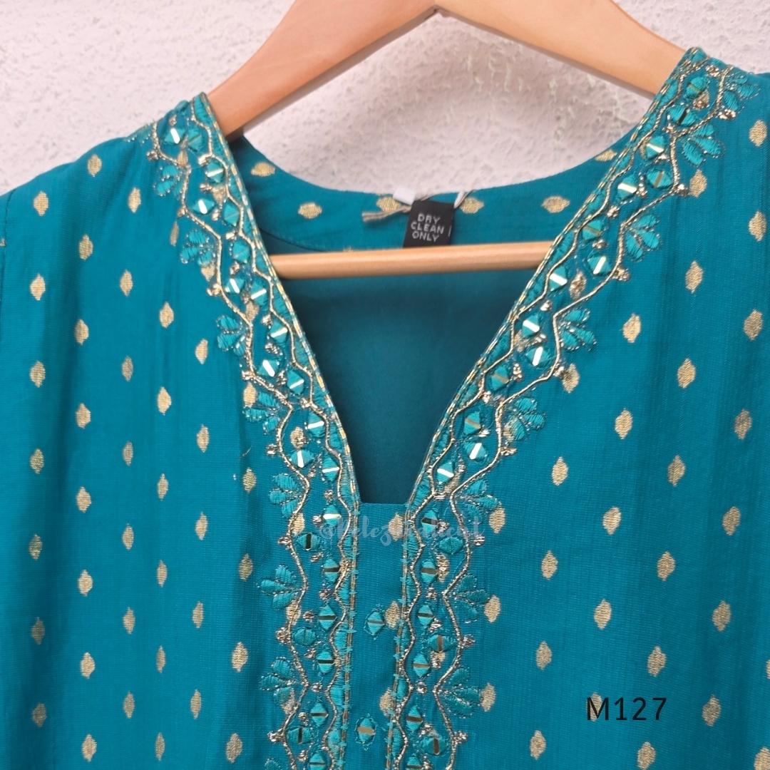Peacock teal silk blend 3-piece churidar set with gold buti motifs, decorated V-neckline, plain matching bottom and gold-bordered dupatta.