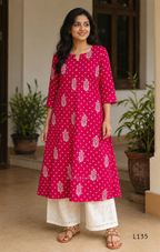 Raspberry pink cotton kurta top with white floral buti print, centre pleat detail, 3/4 sleeves, and relaxed A-line fit.