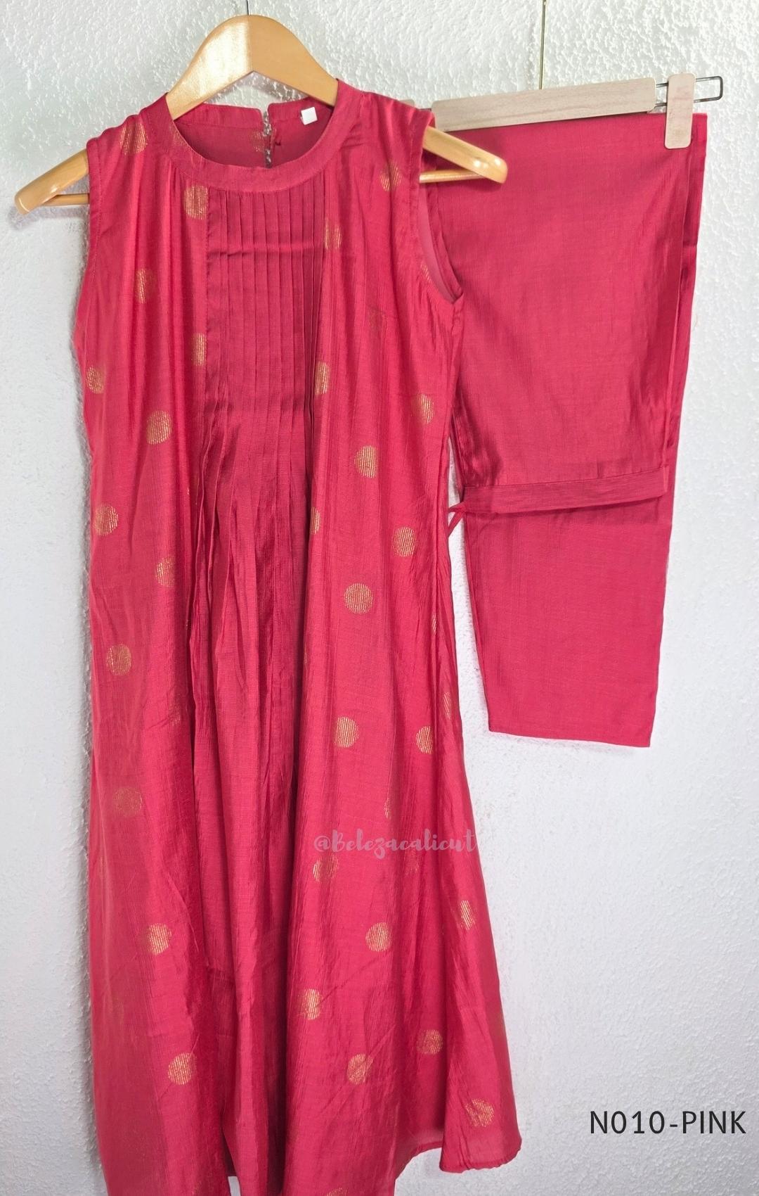 Raspberry pink Vertigan silk coord set with sleeveless pleated A-line top, gold circular side motifs and matching straight pants.