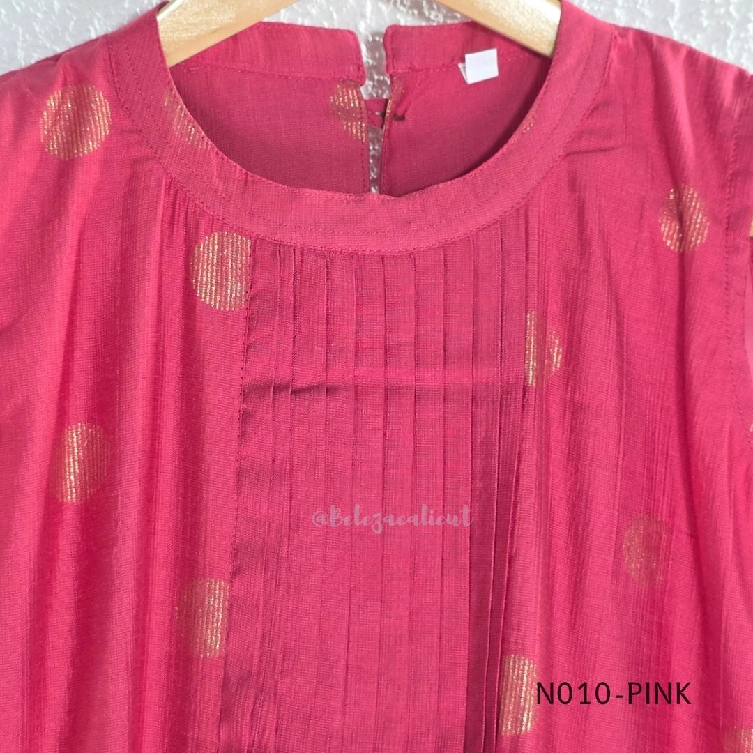 Raspberry pink Vertigan silk coord set with sleeveless pleated A-line top, gold circular side motifs and matching straight pants.