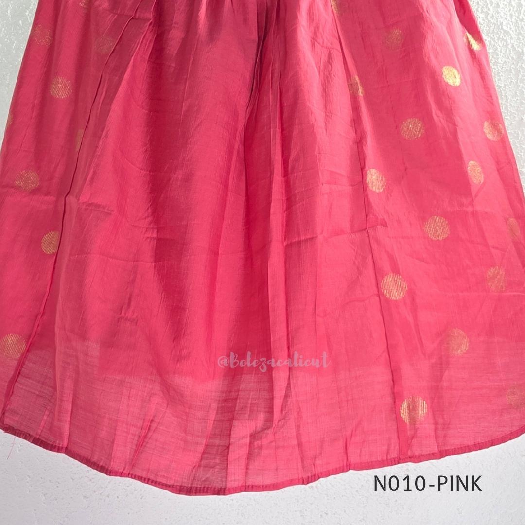 Raspberry pink Vertigan silk coord set with sleeveless pleated A-line top, gold circular side motifs and matching straight pants.