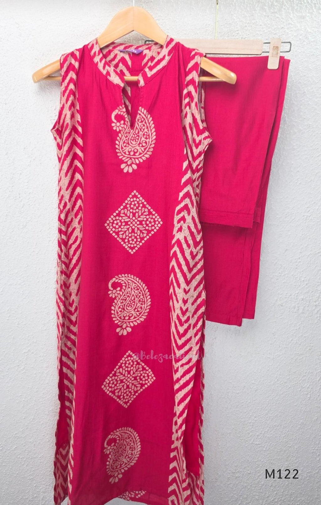 Raspberry pink Vertigan silk two-piece co-ord set with beige paisley, diamond and chevron print and matching straight pants.