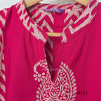 Raspberry pink Vertigan silk two-piece co-ord set with beige paisley, diamond and chevron print and matching straight pants.