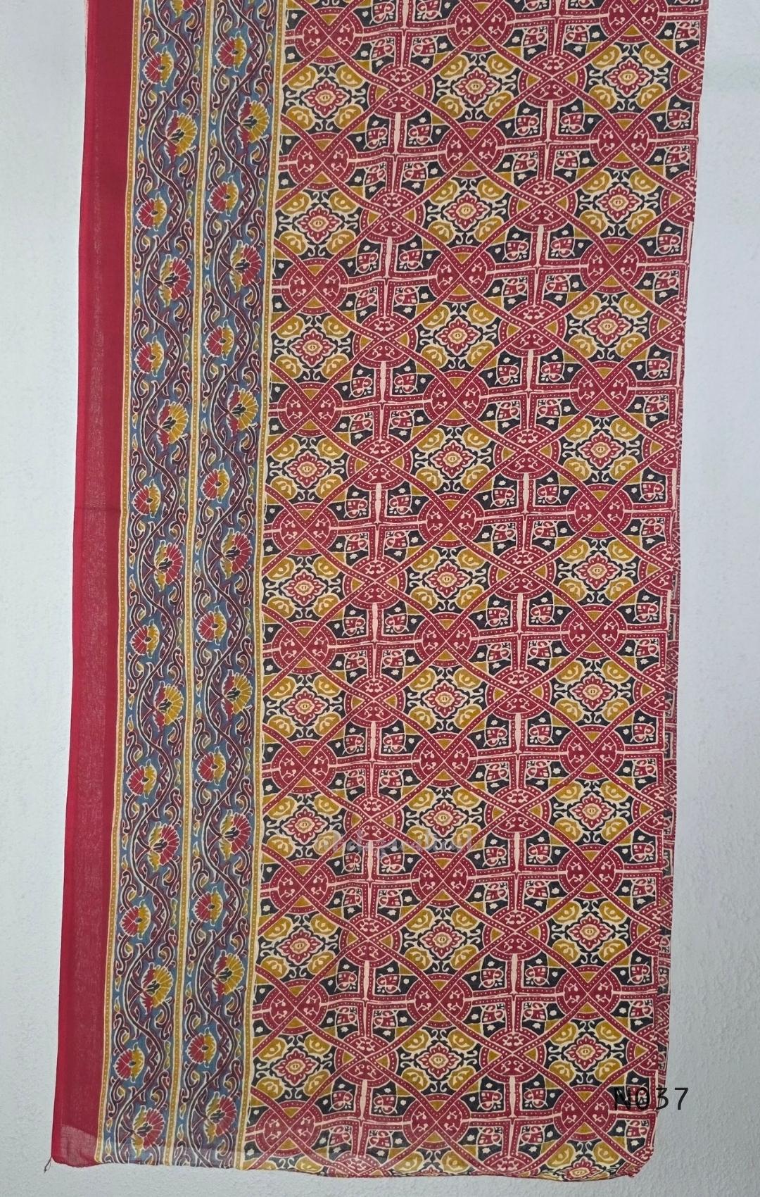 Raspberry red cotton 3-piece churidar set with a printed V-neck border, mirror-and-tassel yoke, diamond motifs, printed sleeves, straight pants and a printed dupatta.