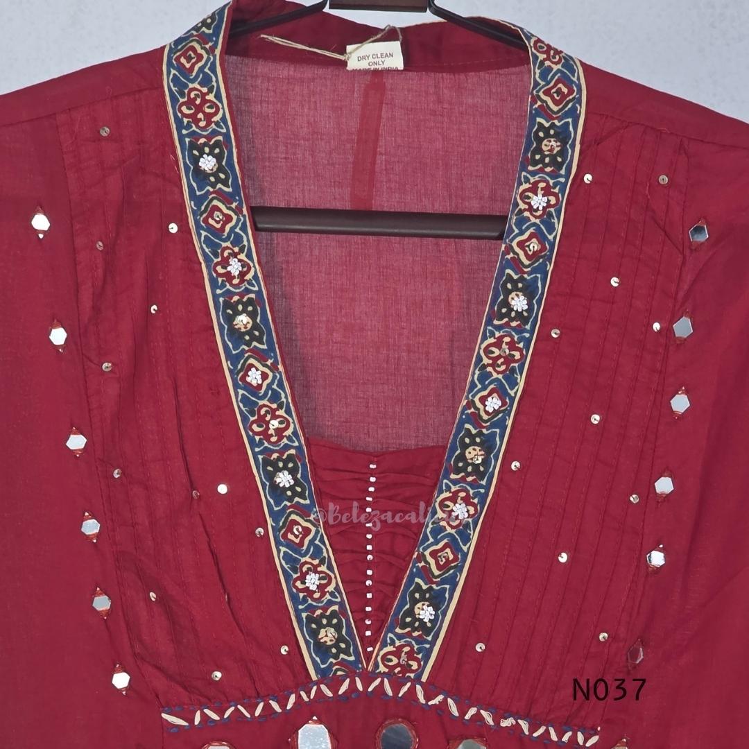 Raspberry red cotton 3-piece churidar set with a printed V-neck border, mirror-and-tassel yoke, diamond motifs, printed sleeves, straight pants and a printed dupatta.