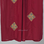 Raspberry red cotton 3-piece churidar set with a printed V-neck border, mirror-and-tassel yoke, diamond motifs, printed sleeves, straight pants and a printed dupatta.
