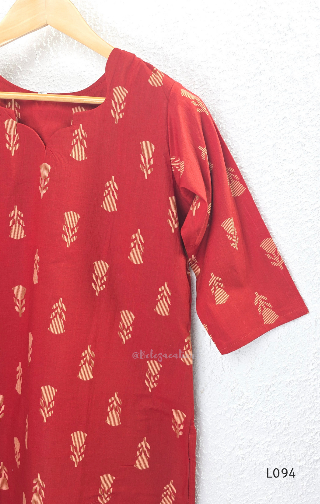 Red cotton women’s top with beige leaf print, small notch neckline, elbow sleeves, and straight everyday fit.