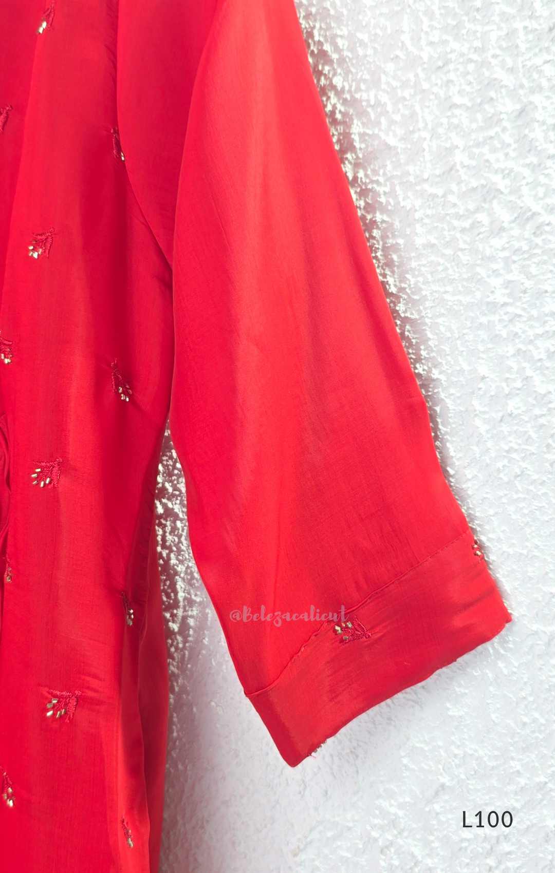 Red mul chanderi A-line kurti with V-neck, gathered front panel, 3/4 sleeves and small scattered embroidery.