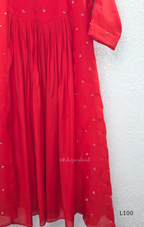 Red mul chanderi A-line kurti with V-neck, gathered front panel, 3/4 sleeves and small scattered embroidery.