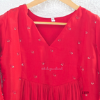 Red mul chanderi A-line kurti with V-neck, gathered front panel, 3/4 sleeves and small scattered embroidery.