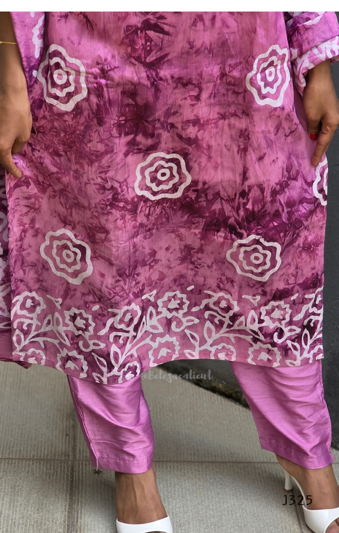 Purple outfit with floral patterns on a neutral background