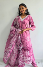 Woman wearing a pink traditional outfit with white patterns on a plain background