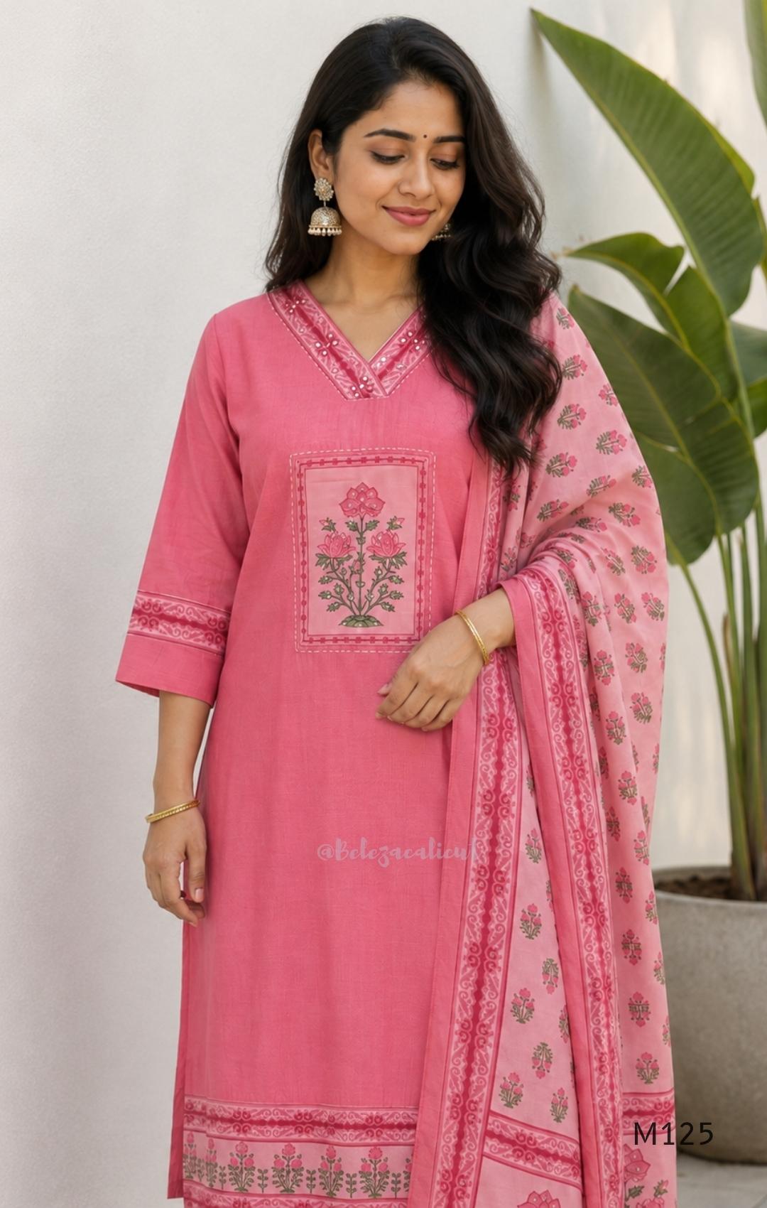 Rose pink silk blend 3-piece churidar set with floral patch panels, decorated V-neck, loose plain bottom and printed floral dupatta.