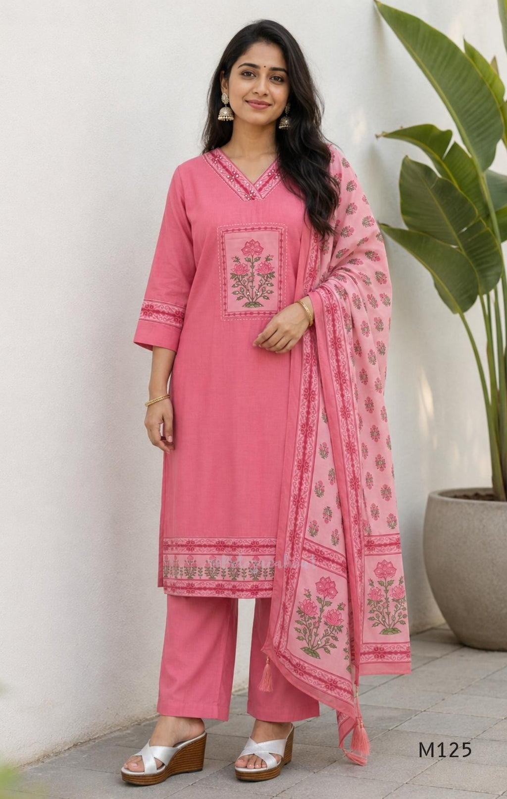 Rose pink silk blend 3-piece churidar set with floral patch panels, decorated V-neck, loose plain bottom and printed floral dupatta.