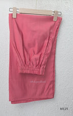 Rose pink silk blend 3-piece churidar set with floral patch panels, decorated V-neck, loose plain bottom and printed floral dupatta.